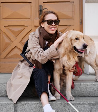 Person with limited mobility outdoors with their dog